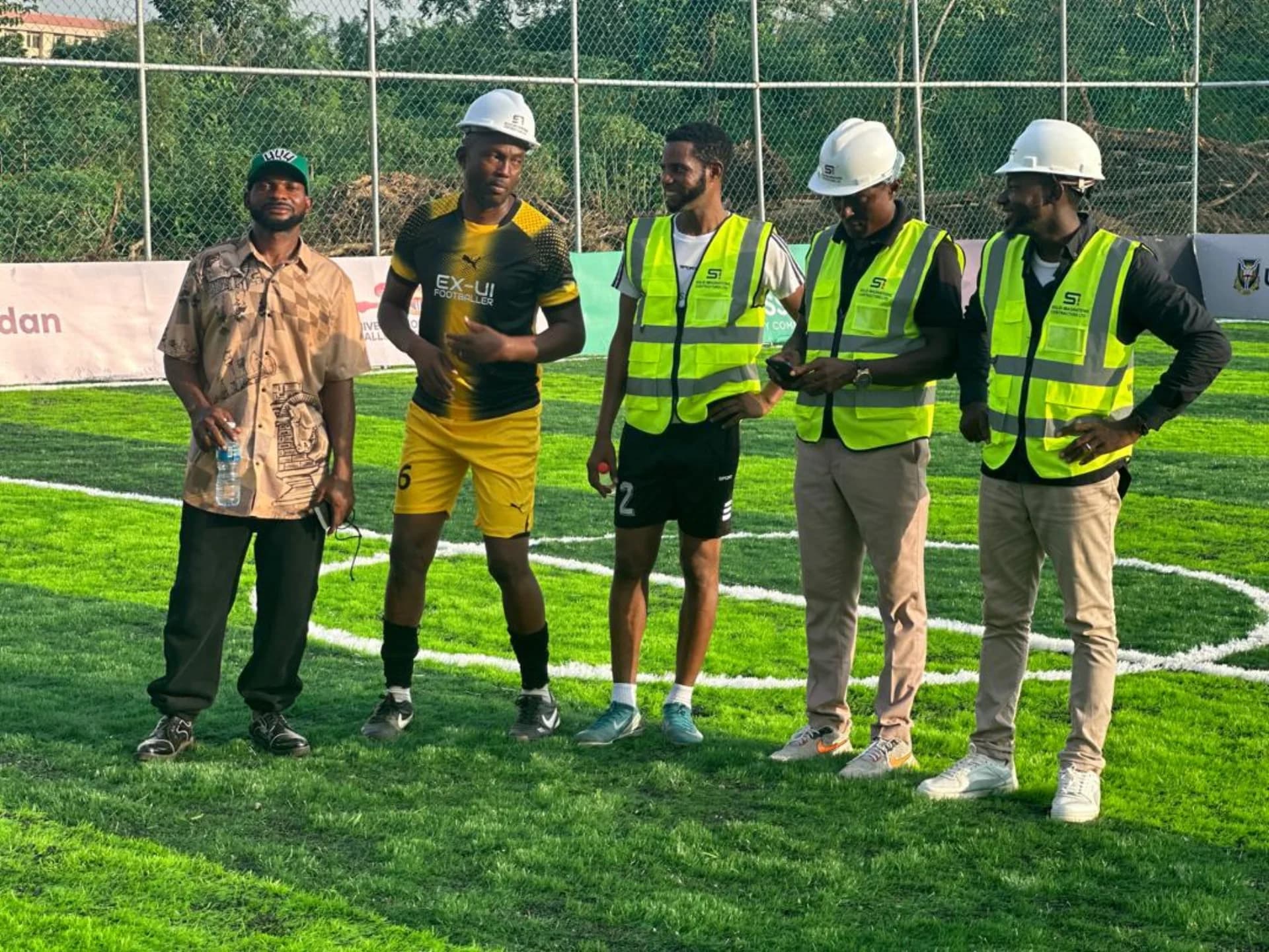 Site team and guests at pitchside after project completion